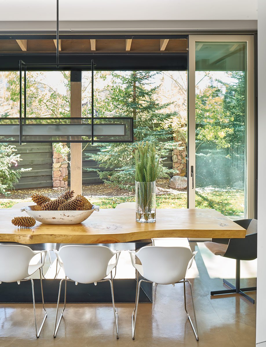 verticalarts's tweet photo. This cedar live-edge table compliments the wooded area outside the dining room of this #VAdesigned #remodel. (Light fixture: @hammertoninc) #architecture #VAdesigns #interiors #grandlake #mountainliving #diningroom #design https://t.co/UblDEyGOnk