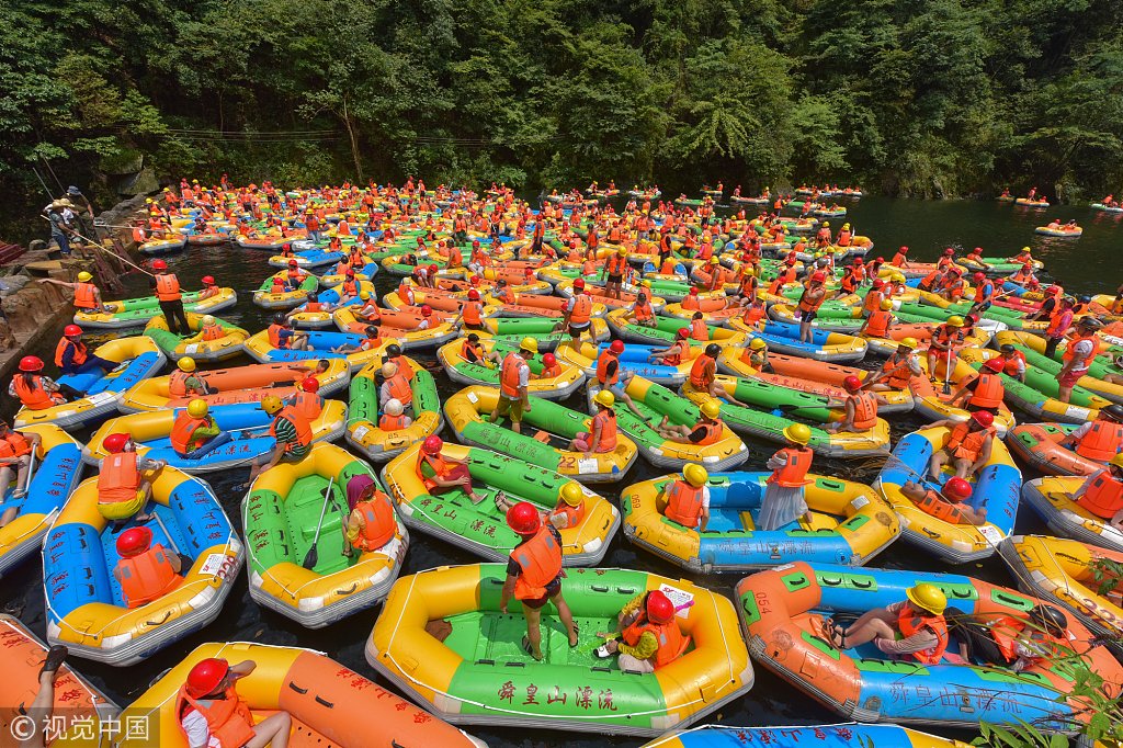 ChinaDaily's tweet photo. Look at these colorful “dumplings”! Tourists enjoy rafting in South China’s Hunan province. (Photo: VCG) https://t.co/ydEwWPcjgP