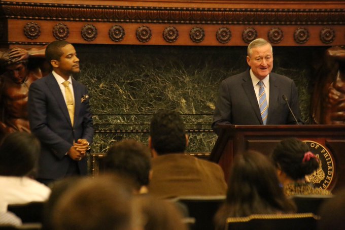 The Mayor standing at a podium alongside City Solicitor Marcel Pratt.