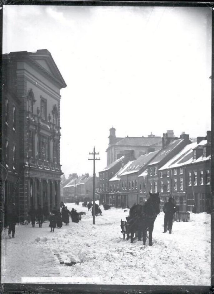 Water Street, David Sclater and Standard Clothing House, snow covered street, with horse drawn carts, pre-1892.