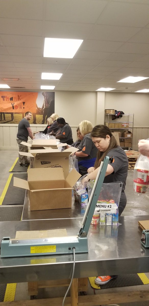 Team Aflac Omaha on the Food Bank assembly line packing lunches for their children's backpack program #24HOI #wedontcoast #WeImpact #aflac #duckprints