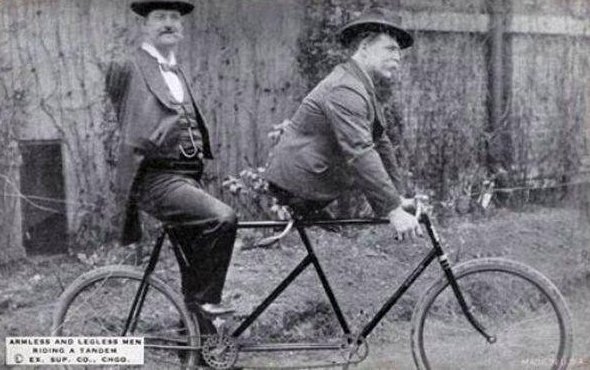 Charles B. Tripp, the armless man and Eli Bowen, the legless man, riding a tandem. 1890s