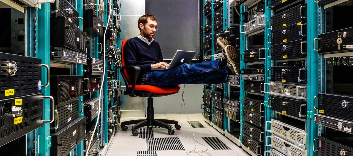 Look, it's important to sit comfortably while monitoring from the hot aisle of the data center.   Why wouldn't I prop my feet up?    (Also, I occasionally string Ethernet cables diagonally across 3 racks, sure) #BadStockPhotosOfMyJob