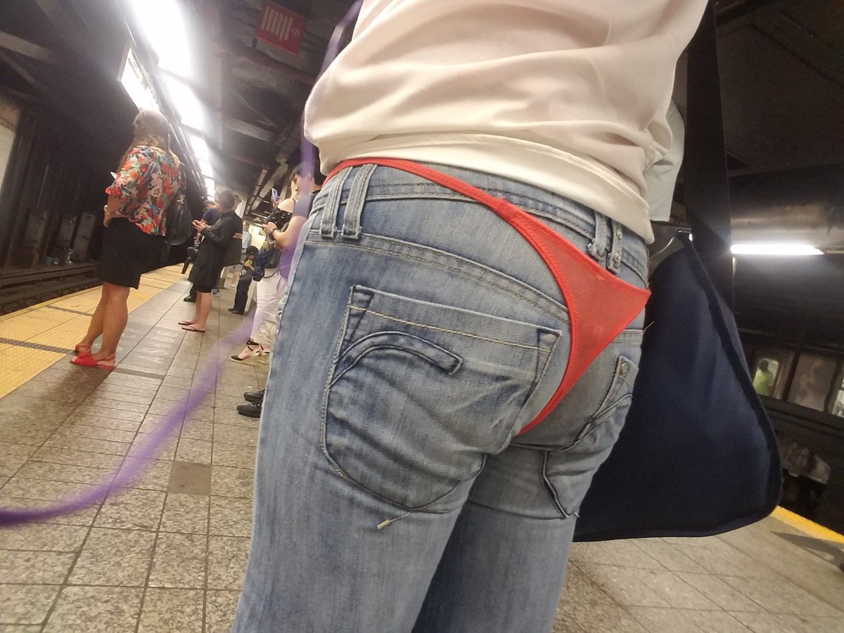 Woman wearing thong underwear over jeans on the. 