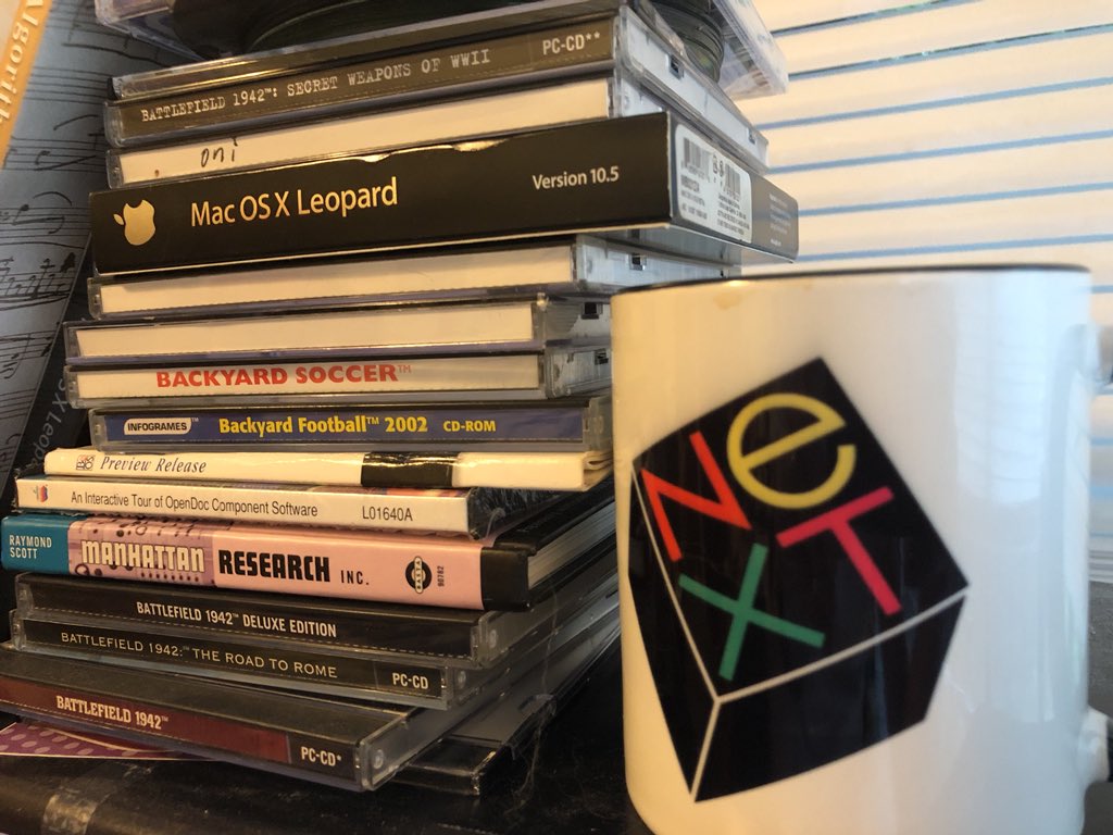 ibis's tweet photo. It just occurred to me the shelf above my desk is quite the cross-section of 90’s and early 00’s technology and games. #NeXT #beos #OpenDoc #SCUMM #knowYourRoots https://t.co/uFNaJRFmkn