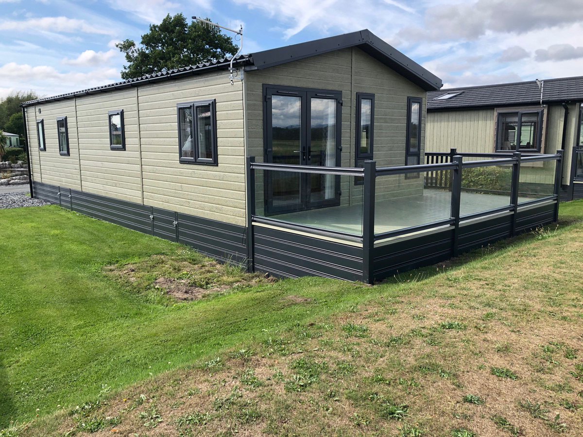 ABSundecksLtd's tweet photo. Why not add a touch of glass for that touch of class? Gorgeous glass panelled wraparound with cream deck boards on this lovely home at #Lakesway, its slate grey handrails and skirting complimenting the home perfectly. https://t.co/T12A30mNlF