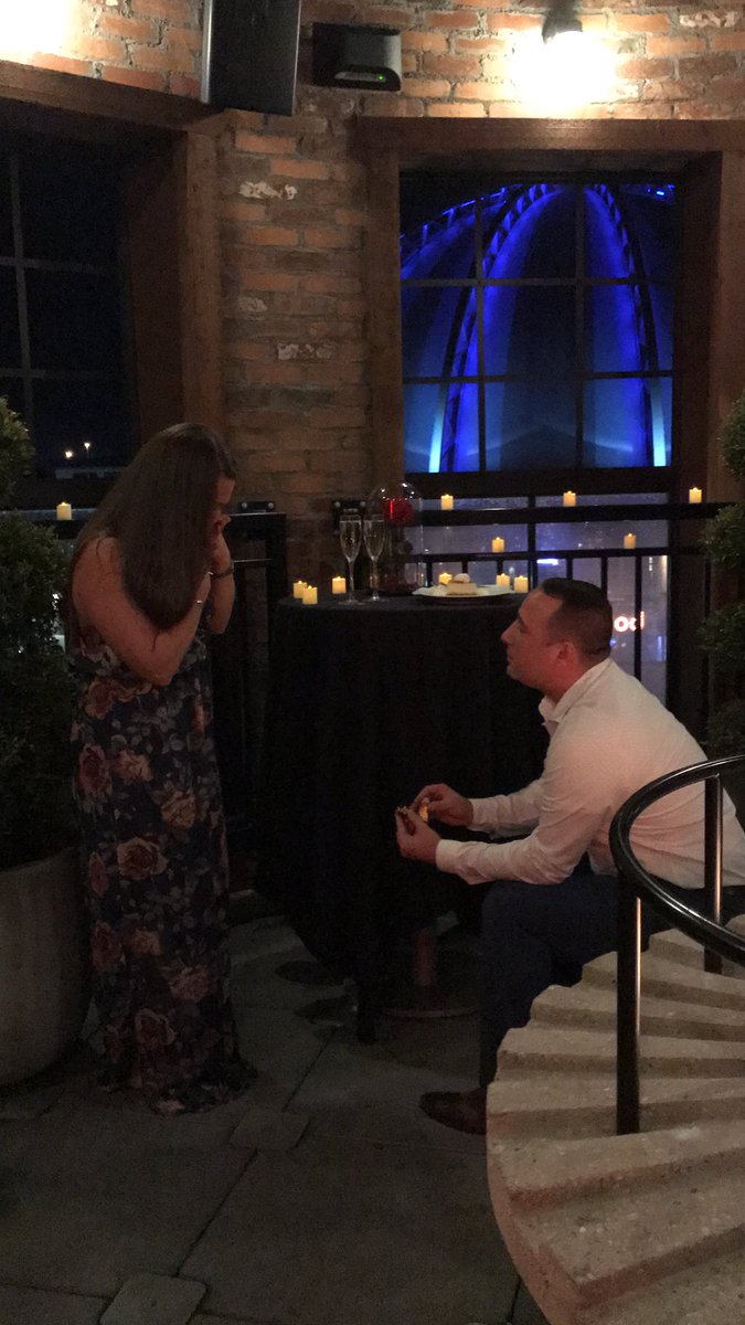 Coach_RSaunders's tweet photo. So this happened last night.. she said YES!! 💍🍾♥️ Thank you to the staff from @eatSTK at Disney Springs for setting up the private rooftop terrace for a PERFECT proposal!! #DisneyIsMagical #UntilTheLastPetalFalls https://t.co/KELH4zoKMK