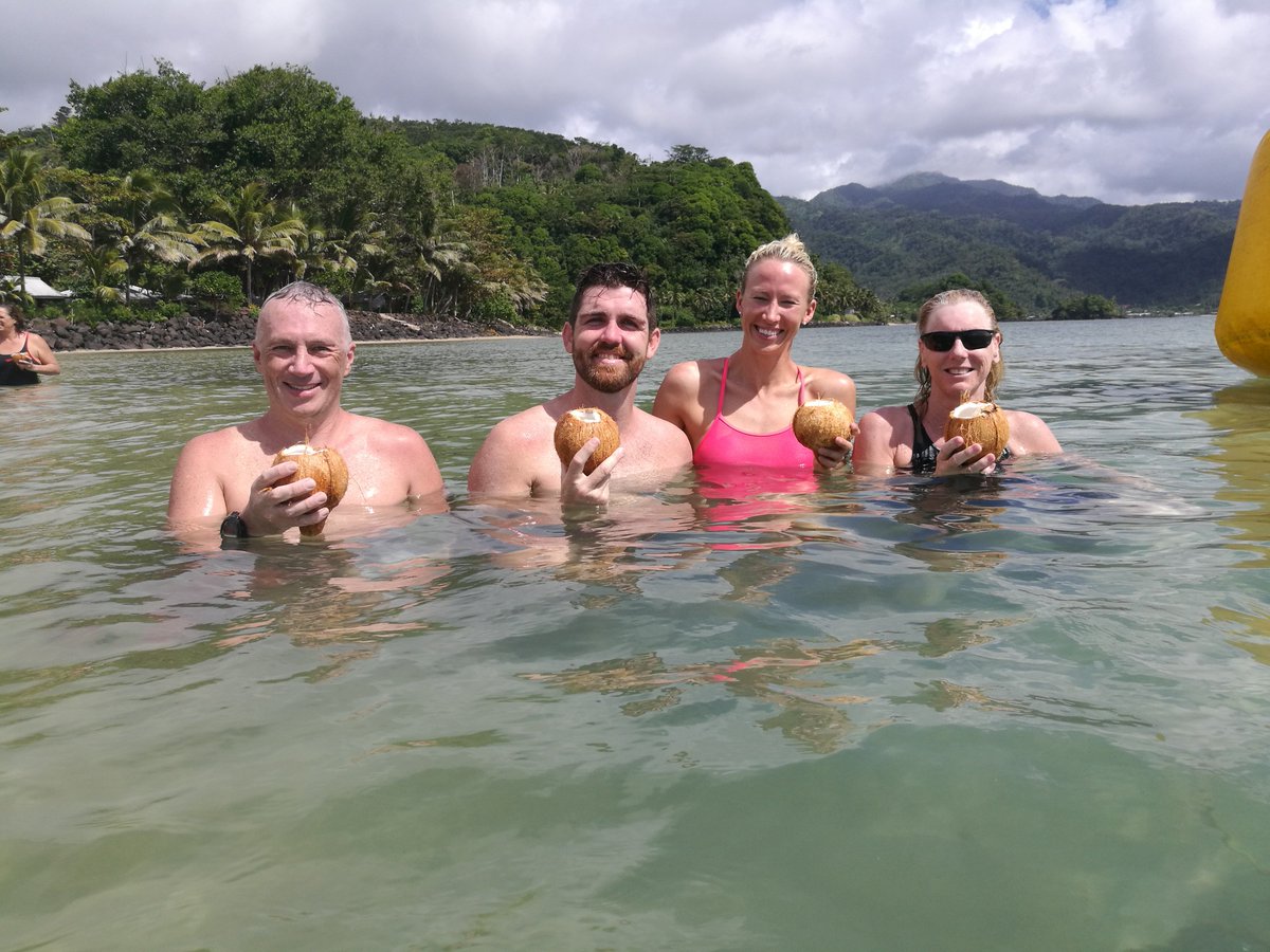 samoaswim's tweet photo. 15 km DONE - Mike, Scott, Jess, and Christina relax with a cool coconut at the end of the long Swim RESULTS for 10 km and 15 km up soon #samoaswims #samoaevents #OWS #pacificswim https://t.co/FXaZ4dXpDb