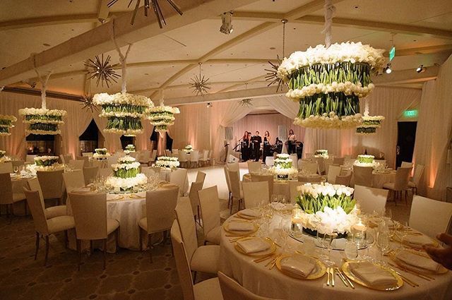 We love this photo shared by <a href="/bobgailevents/">Allyson Levine</a> that combines our sleek white chair covers and gorgeous hanging florals installations. || Photography: @adinextexit <a href="/catnextexit/">Cat Krantz Benner</a> | Guest Seating: @chameleonchaircollection @brighteventrentals <a href="/by_dzign/">By Dzign</a>