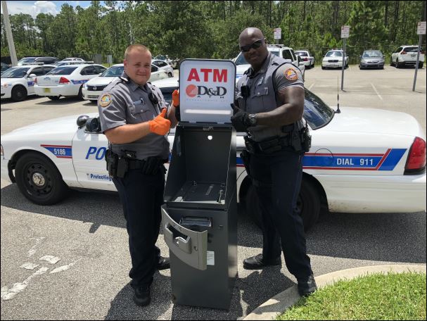 ATM FOUND ON TRACKS. It's not your typical discovery. @DBCops1 Officer Kevin Hird found this ATM on the railroad tracks off Shady Place, Monday. @DBCops1 Officer Austin Clayton, (L) helps him. Anyone w/ info about this machine, call DBPD, 386-671-5200.