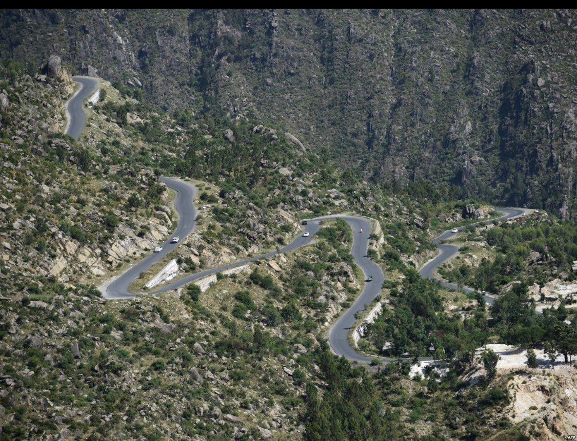 This picture taken on May 18, 2018, shows a road track at a tree plantation site in Buner in northwest Pakistan. The change is drastic: Around the region of Heroshah, previously arid hills are now covered with forest.