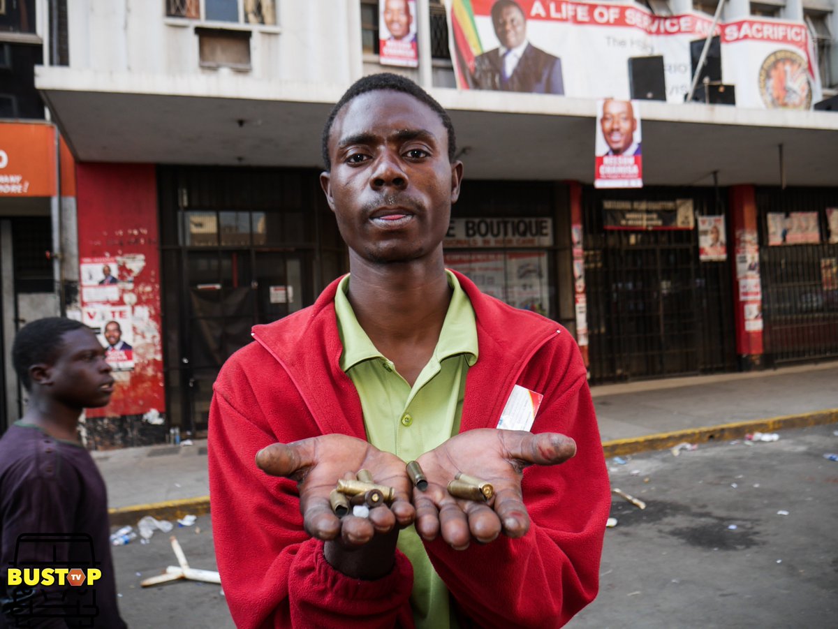 A demonstrator outside Morgan Tsvangirai House (formerly known as  Harvest House) shows live bullet casings from bullets that had been  fired during today's demonstrations by authorities. #LetsGoVoteZW #DefendTheVote #ElectionsZW