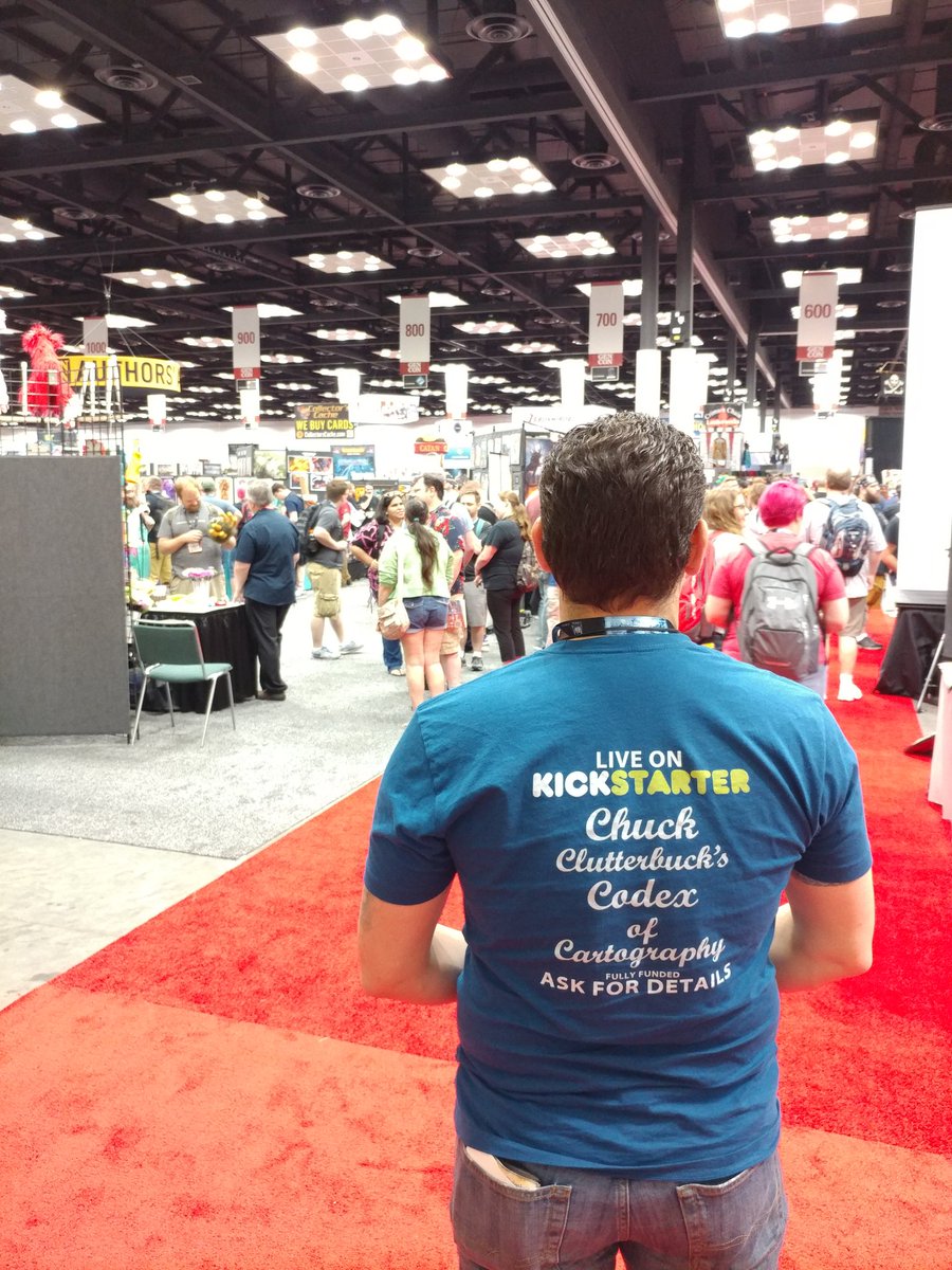 C_Clutterbuck's tweet photo. Checking out the fine art of #GenCon2018 with my friends from @NobleDwarf May buy a new hat while I'm here...  Find us and tweet to receive a free gift. https://t.co/1o1RDcMMkb