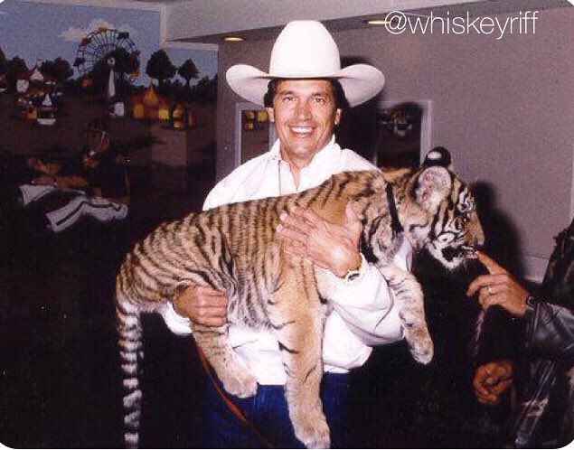 You may be cool but you’ll never be George Strait holding a tiger cool.