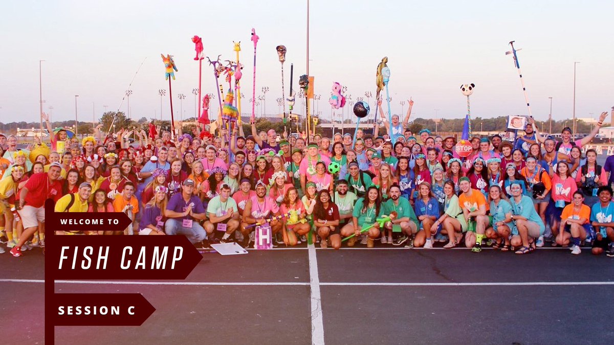 Dozens of counselors in a group photo all wearing brightly colored shirts with text "Welcome to Fish Camp, Session C"