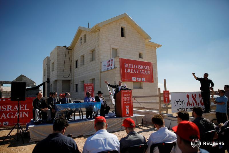 Former Arkansas Governor Mike Huckabee speaks during a ceremony marking the construction of a new housing complex in the Israeli settlement of Efrat in the occupied West Bank