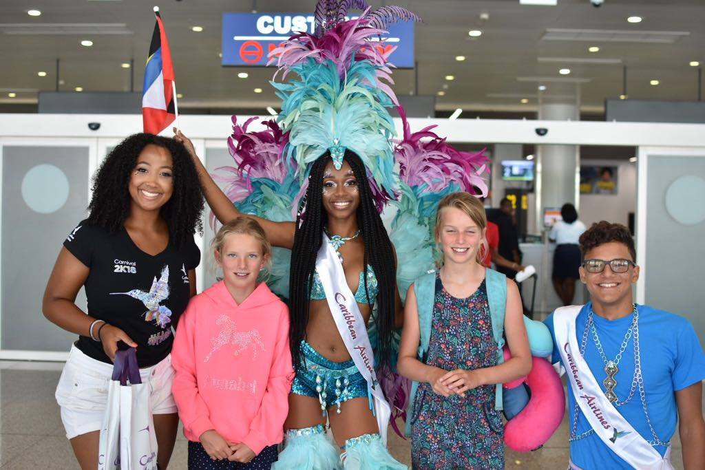 iflycaribbean's tweet photo. We're proud to be the Official International Airline of Carnival in Antigua & Barbuda. We were at V.C. Bird International Airport in Antigua earlier today welcoming passengers with giveaways and pre-Carnival festivities. #iflycaribbean #hellocaribbean #antigua https://t.co/pgq6FgyLSi