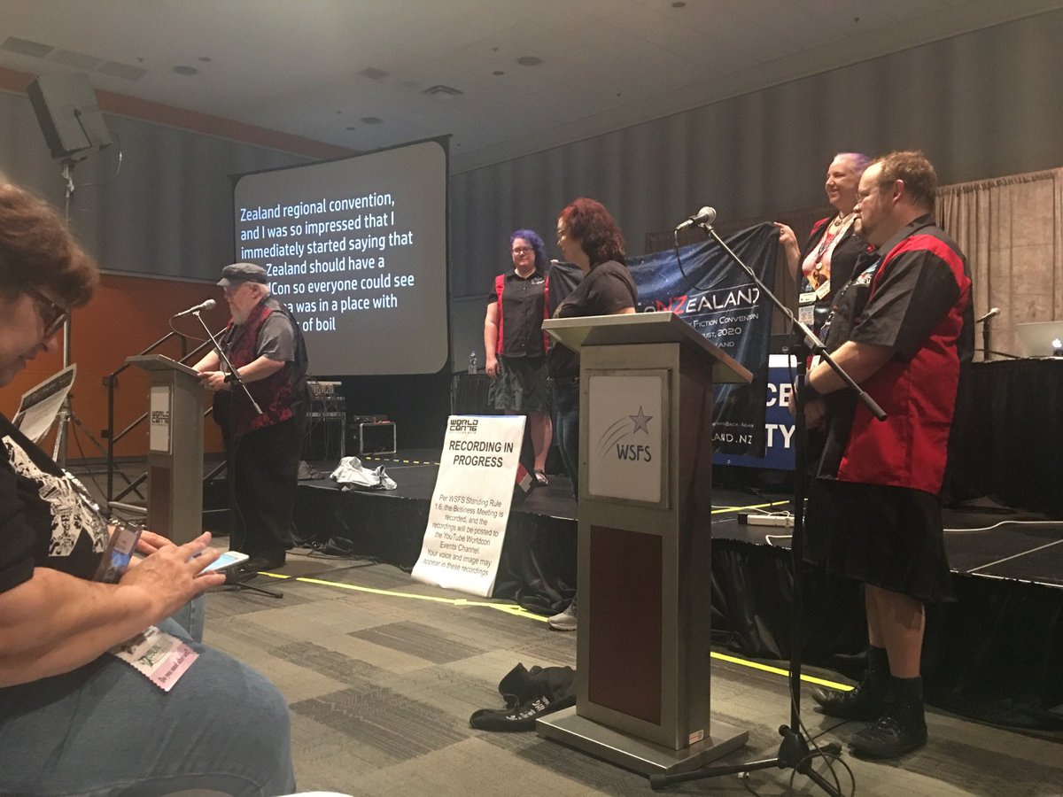 CoNZealand's tweet photo. Our Toastmaster, @GRRMspeaking saying a few nice words about New Zealand at the #WSFSBM, with co-chairs Norman & Kelly. https://t.co/IEpxVPD4xA