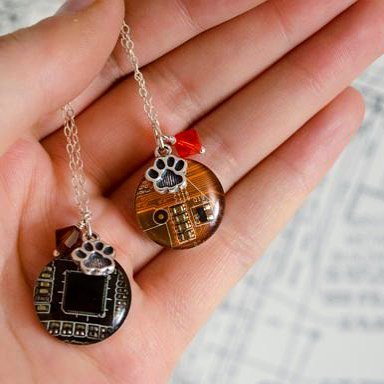 RIT_Alumni's tweet photo. Incoming students aren't the only ones on their way to campus—these amazing, limited-edition #RITtiger paw necklaces will be available at RIT Shop One this fall. They're handmade from reclaimed tech material by Amanda Preske '09 (COS) of Circuit Breaker Labs. https://t.co/YxAacexioV