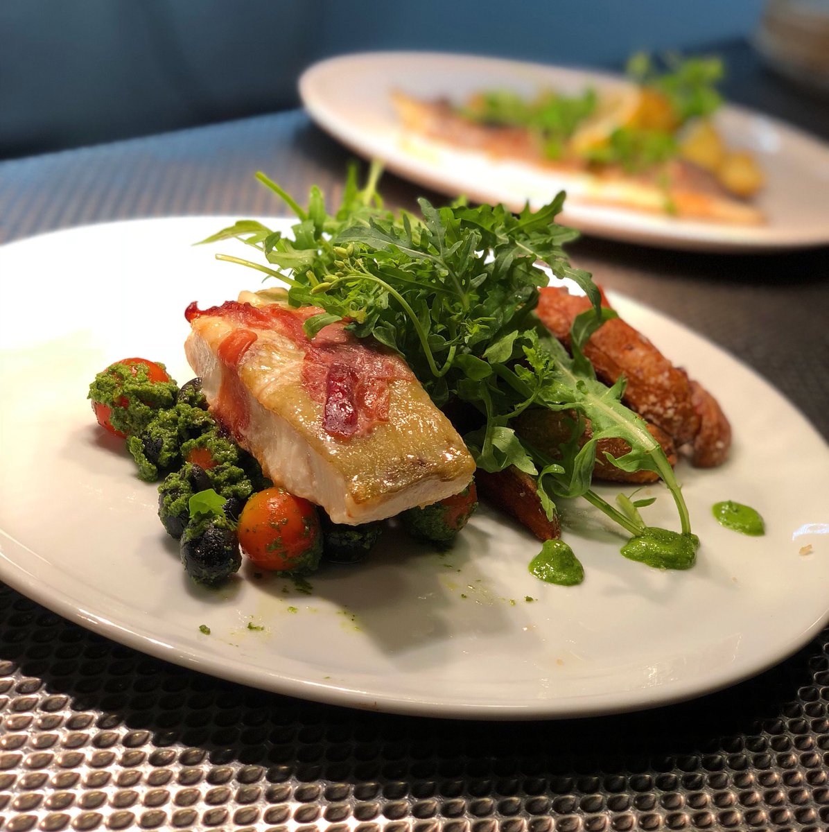 Cod wrapped in parma ham with crispy garlic potatoes, olives, tomatoes and basil pesto🍴 Definitely the winner of our specials board this weekend!💥