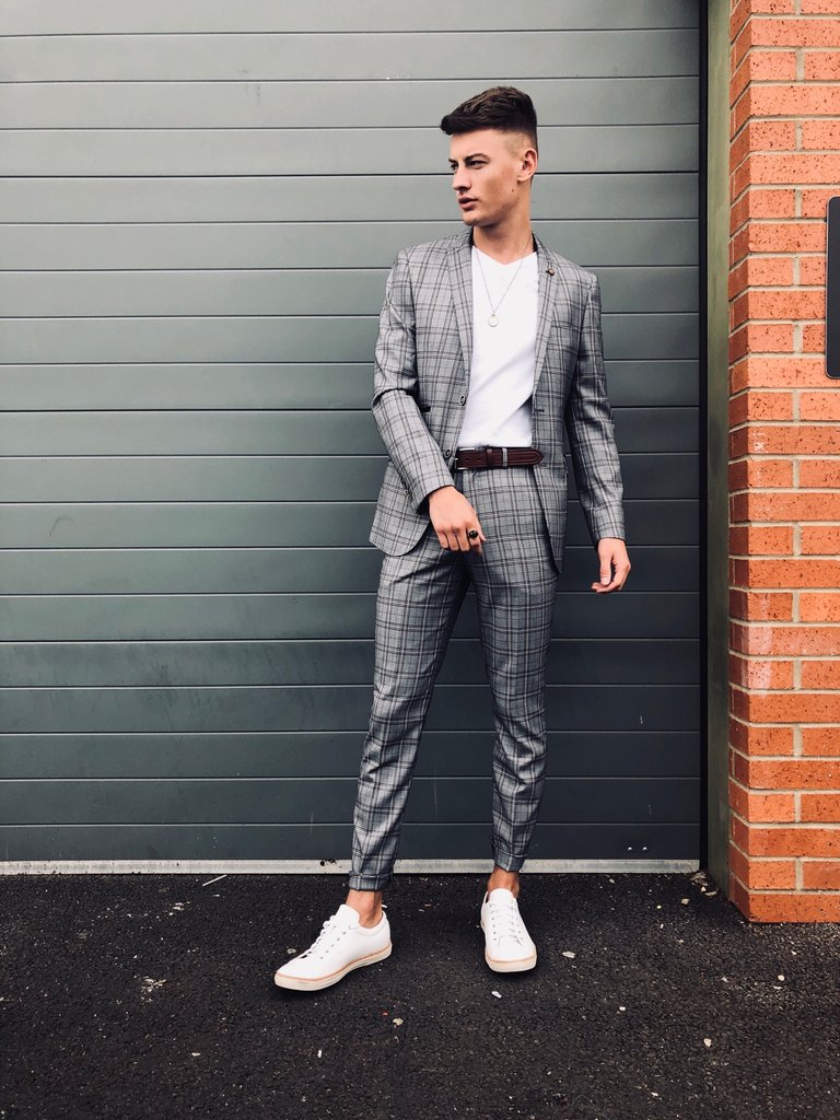 grey suit with white sneakers