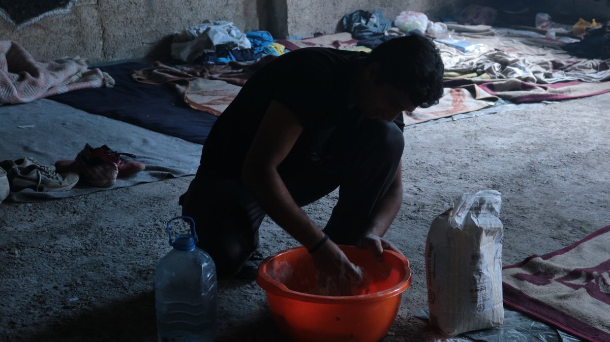 Refugee Camp in Bihac, Bosnia. Cooking is more than a necessity, it is the symbol of our humanity, as we are the only animals that cook. For this reason, preparing bread it is not just a way to feed yourself. It is, first of all, reaffirming your humanity.