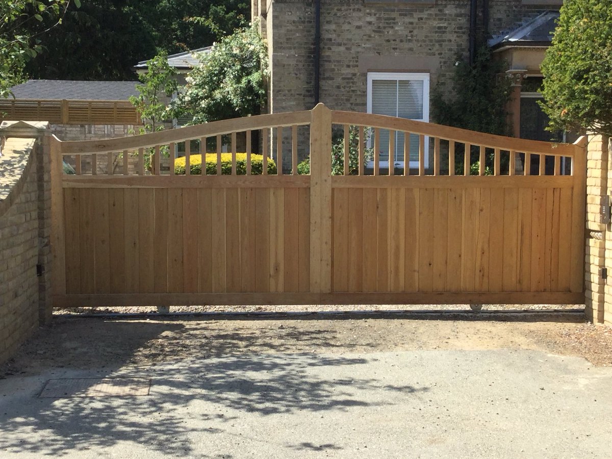 Metal framed wood clad sliding Gate 
zentia.co.uk