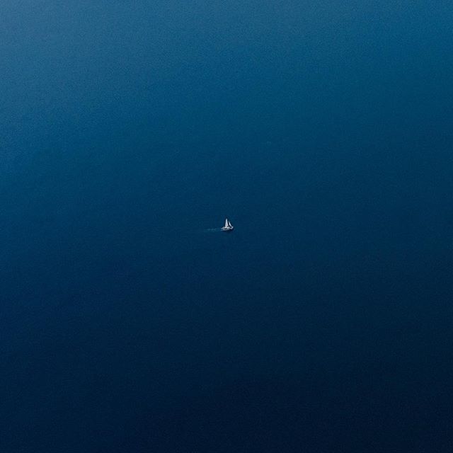 Minimalism, peace, and a calm sense of being. What vibes do you get from this photograph of a sailboat cruising the Pacific Ocean near Hawaii?