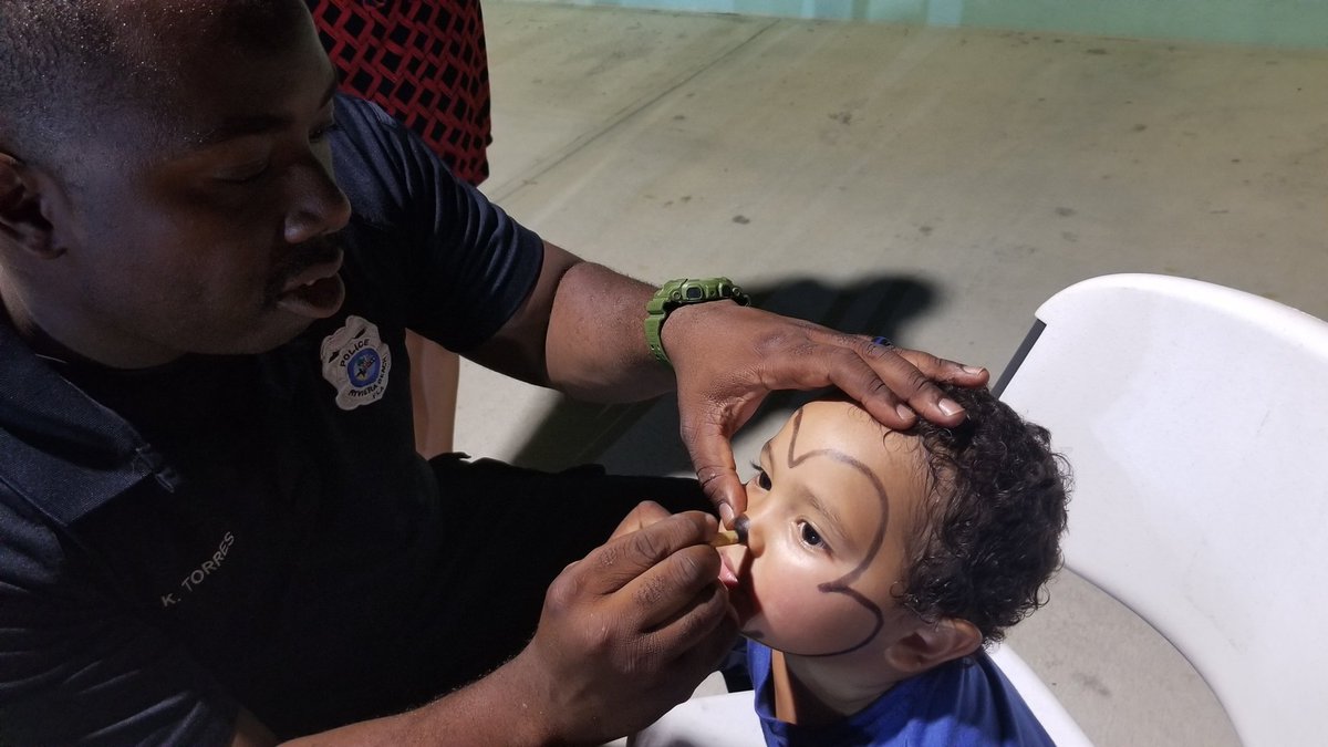 HeySandyPR's tweet photo. Officer Torres has the most important job at #nationnightout in @Rivierabch #facepainting. https://t.co/P32nDcukv8