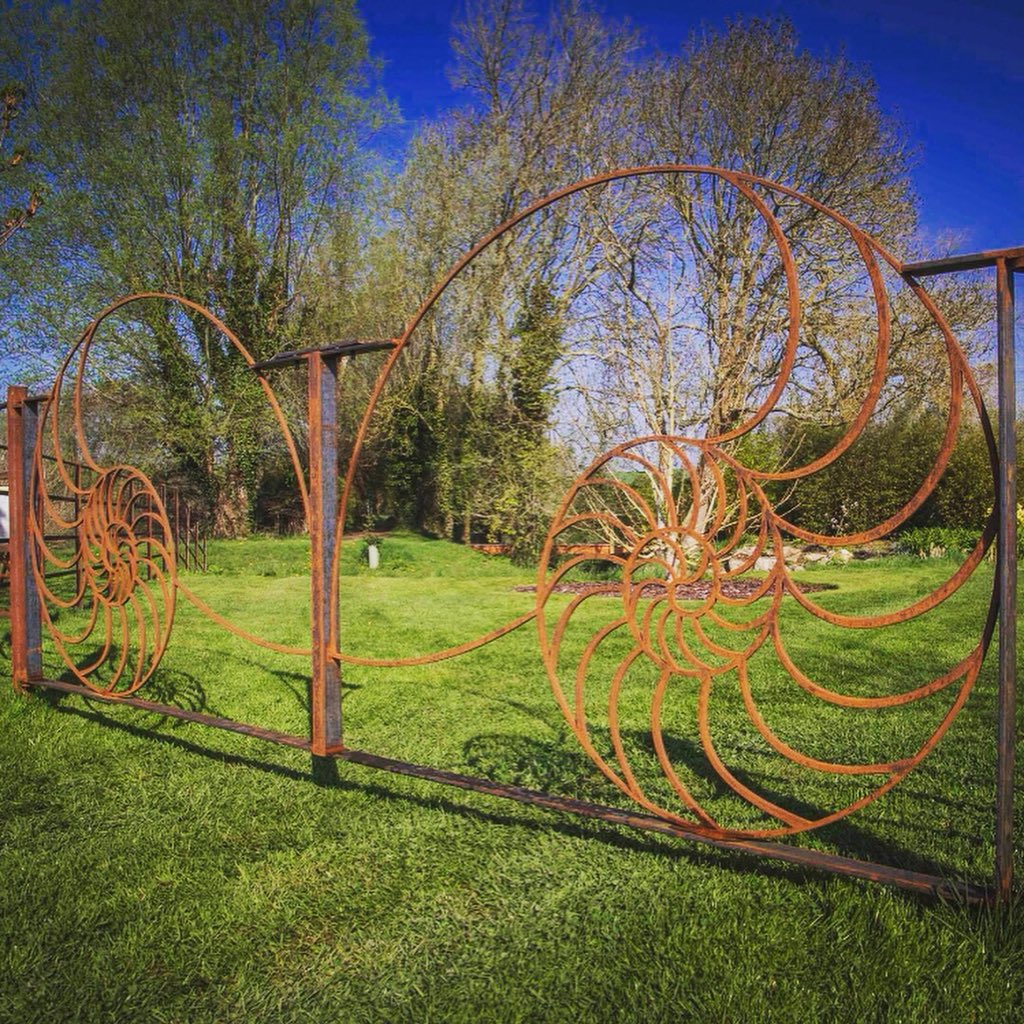 SimonGudgeon's tweet photo. Some of the gates I have designed for my sculpture park @SculptureLakes in #Dorset. Who said gates need to be straight and rigid in their #design? #gardendesign #gardengate #metalwork https://t.co/o12LOTqsN8