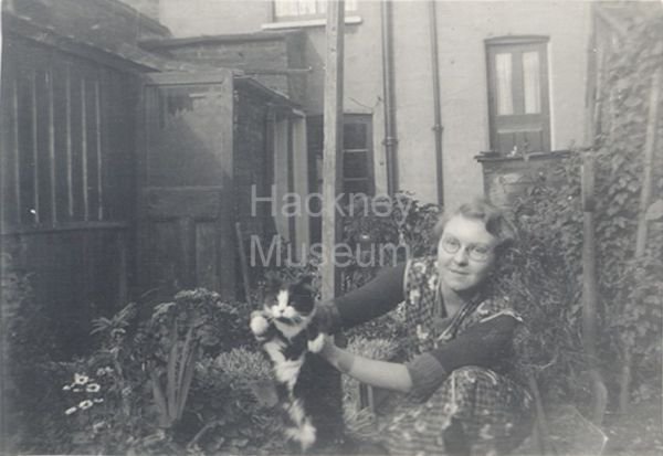 hackneycouncil's tweet photo. It's #InternationalCatDay so here is a photograph from the collection at @HackneyMuseum showing 1940s Hackney resident Catherine wither her pet cat https://t.co/6XbmSoYuua