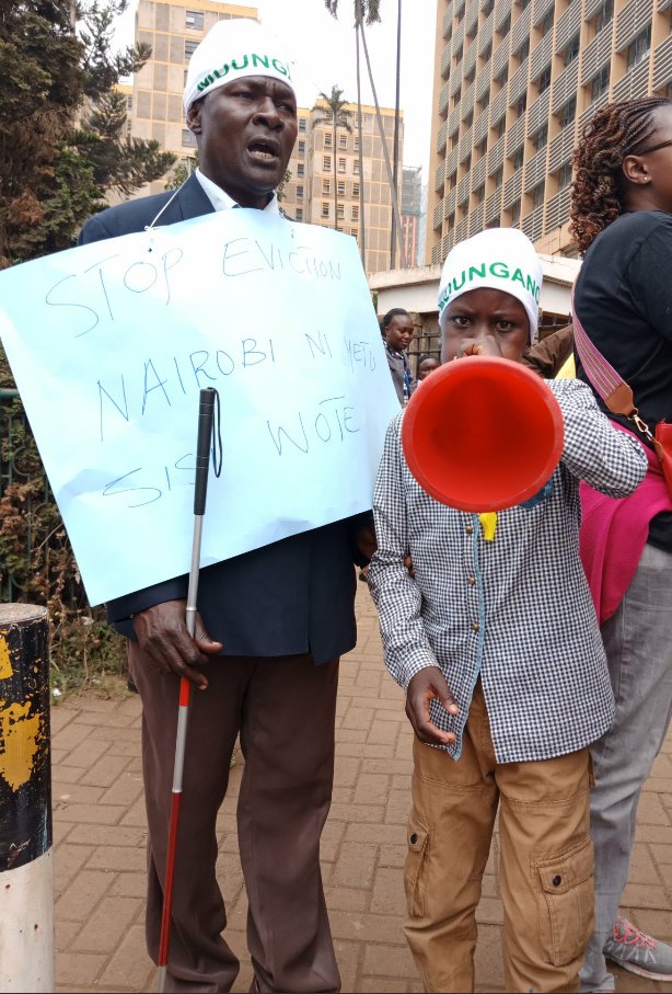 John Kinyanya 50, who is blind and his 11 year old son Amos Yaduto from Kibera joined the march against #ForcedEvictions. No eviction should render anyone homeless in bad weather, without alternative resettlement #MakaoNiHaki