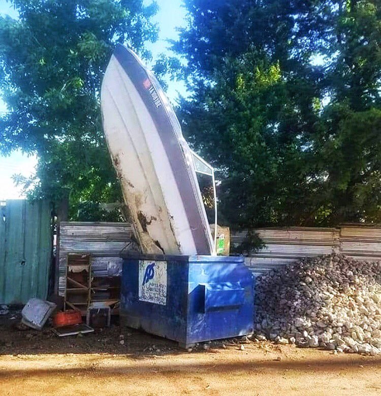 ServiceCarolina's tweet photo. People sometimes ask how far above the top of the dumpster they can fill it. We tell them we have to be able to haul it safely. This is not safe. #funny #avl #avlbusiness #asheville #dumpster #dumpsterdiving #boat https://t.co/q22jpXPlV6