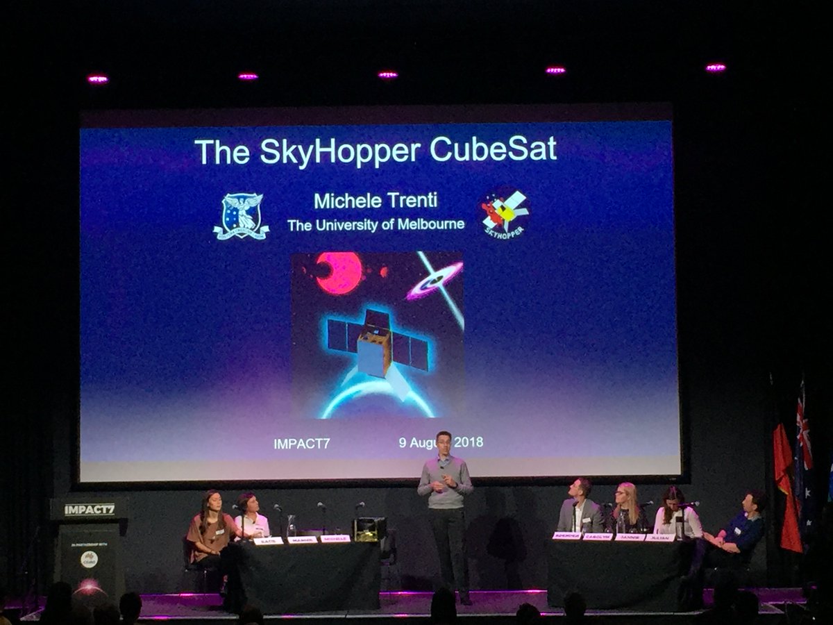 SkyHopper showcased at #impact7: Note the 1:1 aluminum model of the CubeSat on the desk next to Principal Investigator Michele Trenti presenting on the stage.