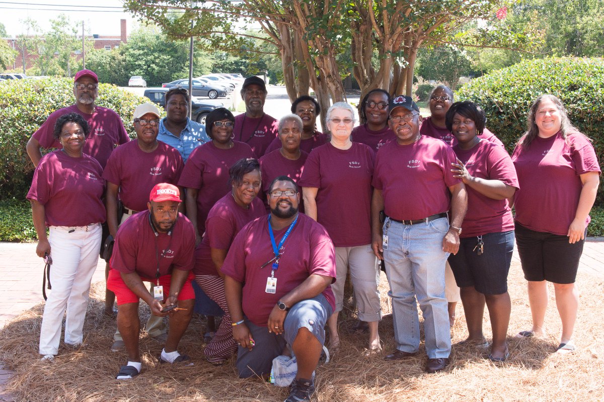 FPSD1's tweet photo. Stand Up, Stand Strong, Stand Together! These bus drivers took to the shaded area today after the whole group photo.  All Florence One bus drivers have spent three days in staff development workshops.  See the whole group photo on Facebook. https://t.co/Ob5EgNqMYp