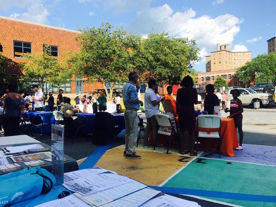 A group of people standing and interacting with each other