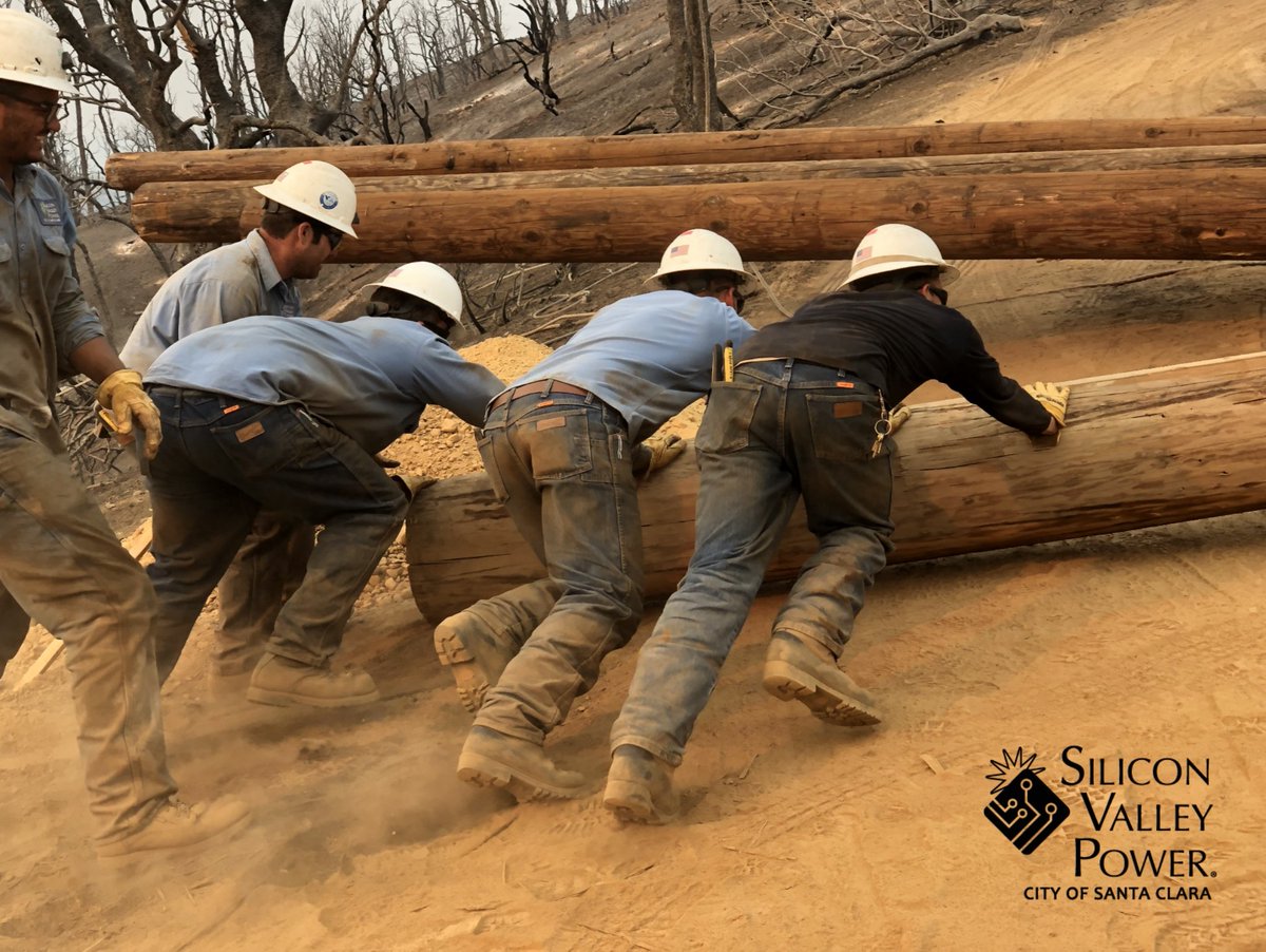 SVP crews roll a 115kV utility pole uphill.