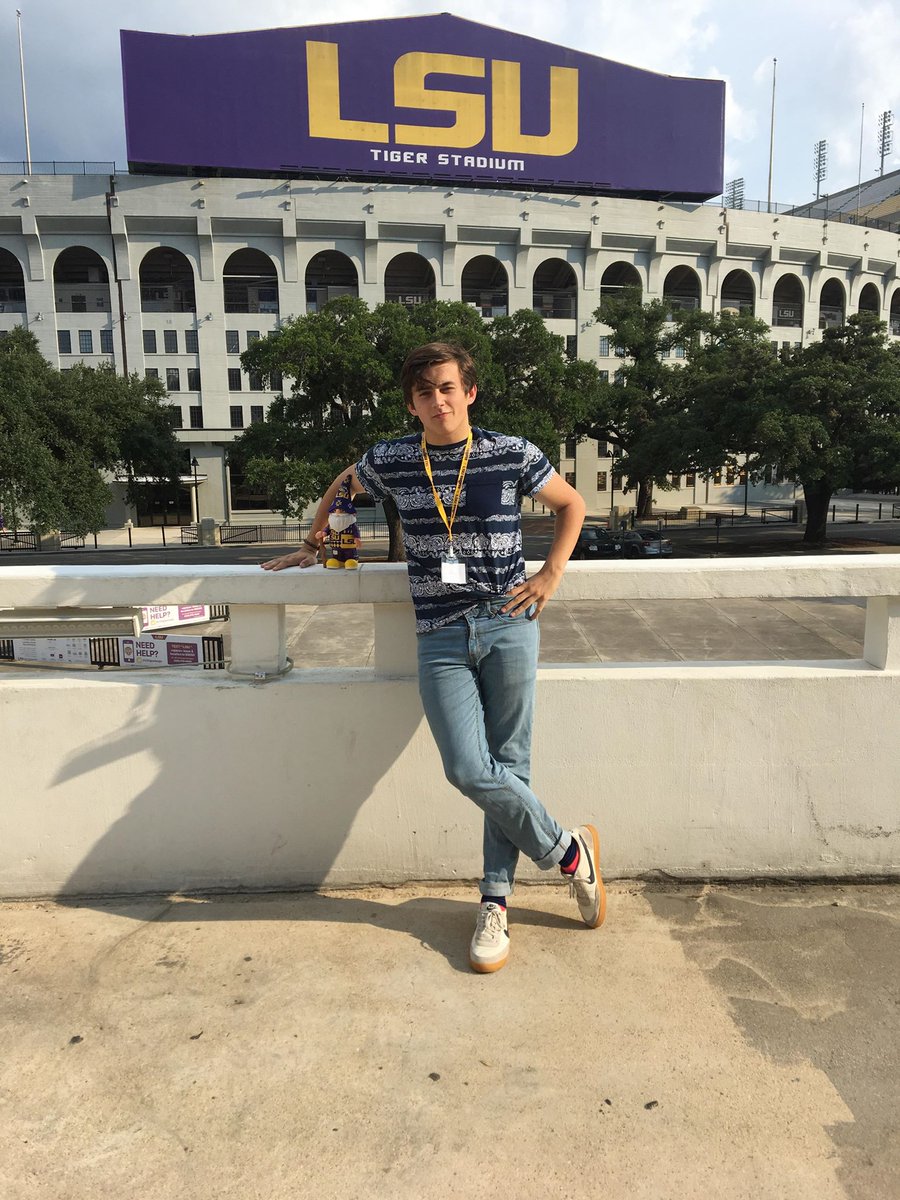 Incoming student Dalton at current age posing outside Tiger Stadium during an orientation session on campus.