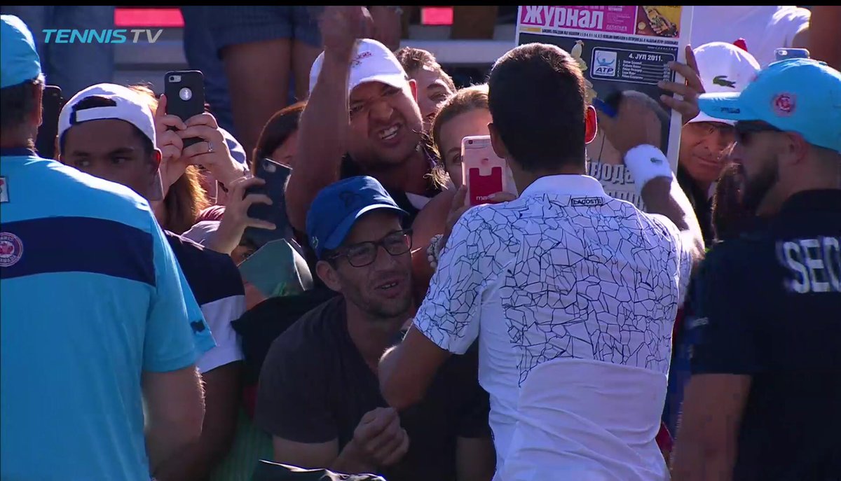 DjokovicUk's tweet photo. Team Djokerson lost their QF match tonight, but that didn’t stop the fans going wild for Nole’s autograph! One guy was making such a noise and was so happy when Nole signed his big photo, he was showing it off to everyone 😆 #NoleFam #FansGoWild https://t.co/upSUG327Qp