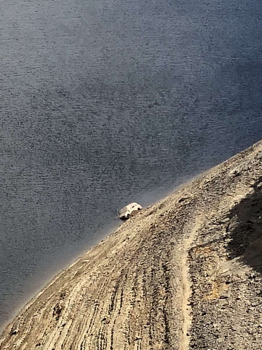 BreconMRT's tweet photo. An unusual call last night from @DyfedPowys to investigate an old @Ford Sierra exposed by receding water levels in Llyn Brianne Reservoir. Two members confirmed the vehicle had been there for many years &amp; (more importantly) was unoccupied. https://t.co/rDHGHlgN9Z