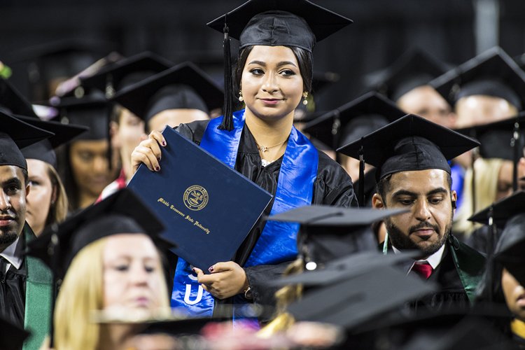 A newly minted MTSU graduate smiles with satisfaction as she sits back down after accepting her degree at the university’s summer 2018 commencement ceremony Saturday, Aug. 11, in Murphy Center. (MTSU photo by Eric Sutton)