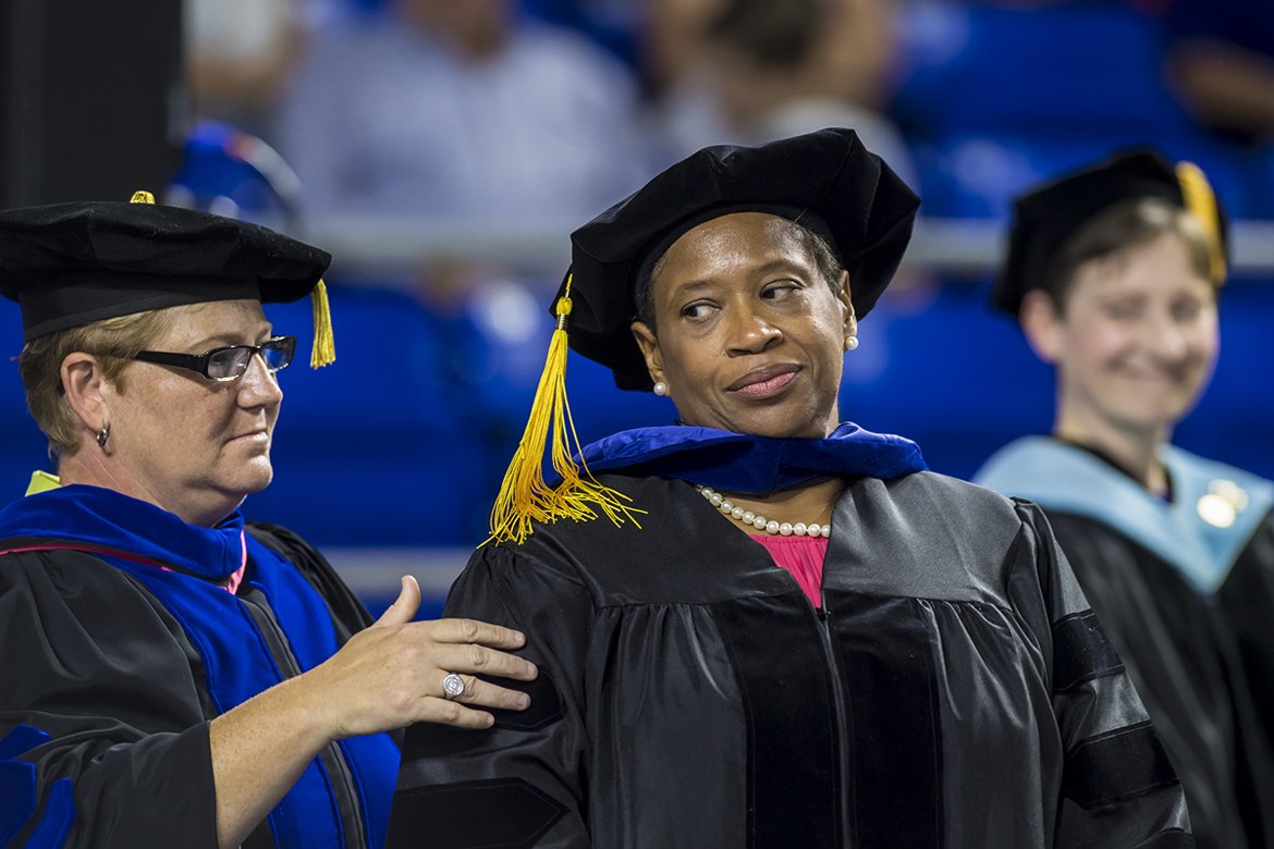 Rita Whitaker, center, shares a moment of accomplishment with her doctoral adviser, MTSU professor Joey Gray, left, after Gray helped Whitaker don the academic hood signifying her new Ph.D. degree in health and human performance Saturday, Aug. 11, at MTSU’s summer 2018 commencement ceremony. (MTSU photo by Eric Sutton)