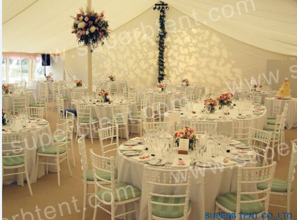 Big wedding party tent with beautiful decors and nice tables and chairs.