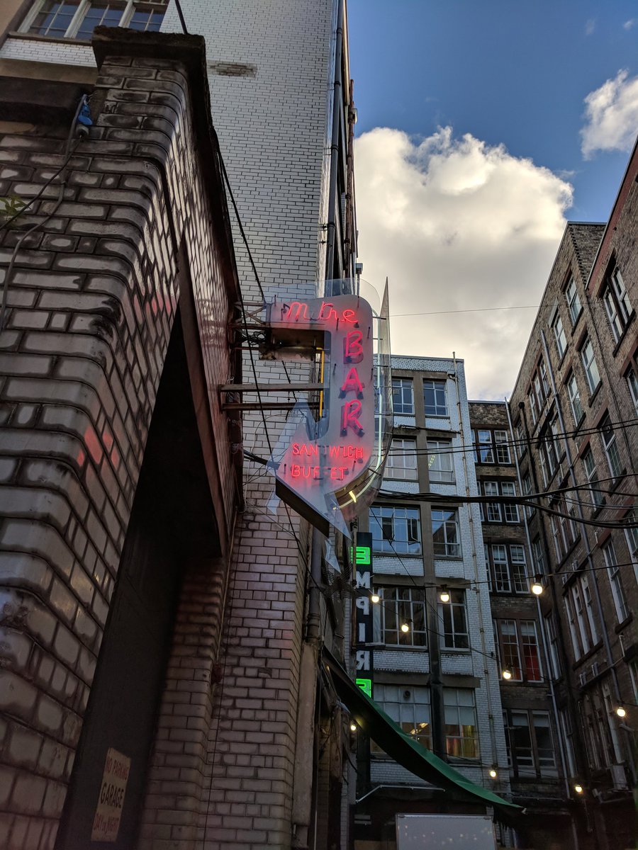 Tontine Lane features early 20th century loading bays and warehouse blocks, finished in reflective white brick to bring some light into an otherwise dark space. Piercing the darkness are two neon signs.