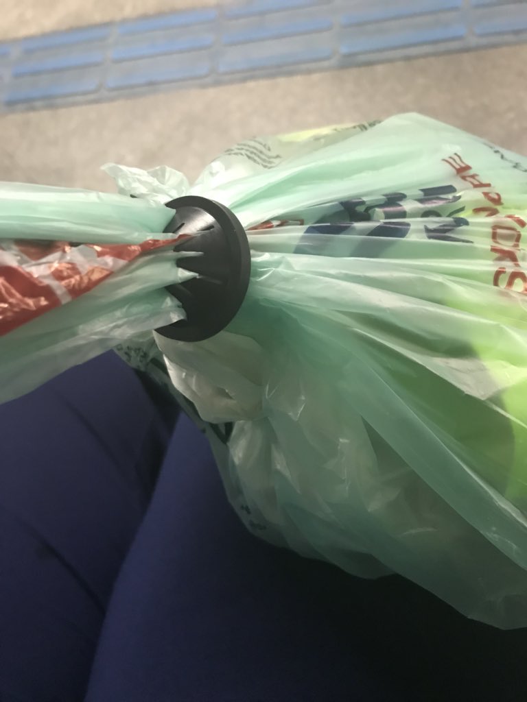 What a great idea for preventing theft...when you enter a store they use a hook to attach this disk to your plastic shopping bag.