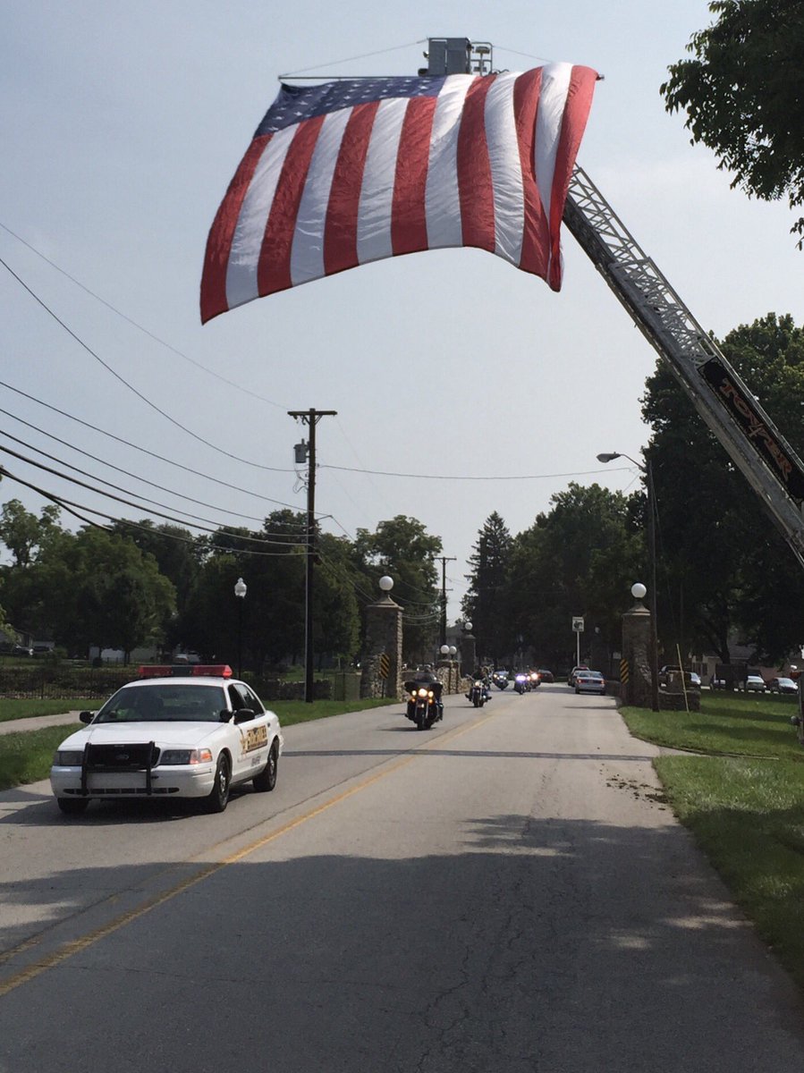 Iaff680's tweet photo. The Spc. Chad Clements Memorial Flag flying over as the Chad Clements Memorial ride,  rides underneath.#hfd680 https://t.co/I9tJLS2yem