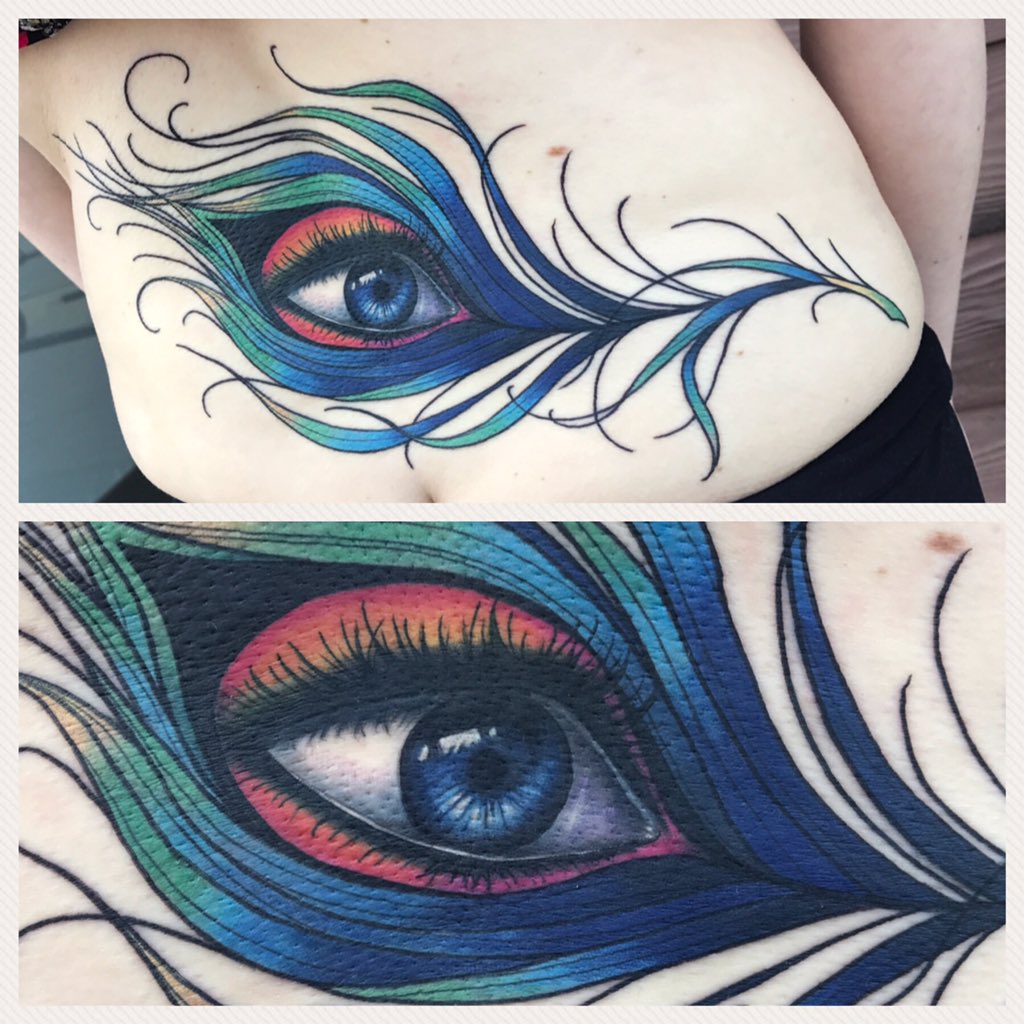 Had a fun time with this peacock feather with eye , also a little cover up  . Swipe to see before and after #peacockfeathertattoo #realisticeyetattoo  #colortattoo #iowatattooartist #fresh #lowerbacktattoo #iowacity #iowa  #tattoos #, image size:1024x1024