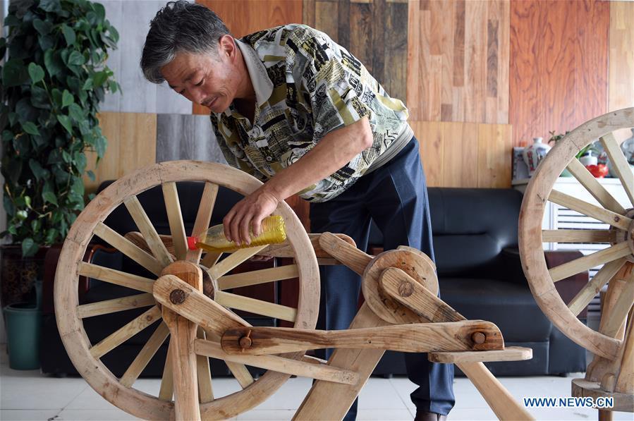 ChinaDaily's tweet photo. 55-year-old Chinese farmer He Yong successfully made a wooden bicycle from scratch. (Photo: Xinhua) https://t.co/6XN8gMfmhQ