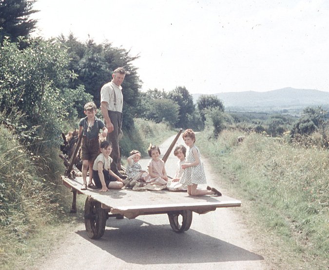 eamonn's tweet image. #Ballylanders #PatternDay &quot;Drawing in” the hay with a horse-drawn “float”was a typical activity around the Pattern Day.  Right to left: Madeleine, Jacqueline, Helen, Mary, Eamonn &amp;amp; Michael John. Towering above us all is Father, in his prime.