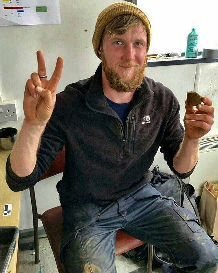 UHIArchaeology's tweet photo. MSc student Ross bringing his #LuckOfTheIrish to site today @NessofBrodgar Ross found two miniature decorated pots or 'thumb pots' in the midden area between Structures 1 and 21. 
#Archaeology #Orkney #NessOfBrodgar
@HistEnvScot @orkneycom @ThinkUHI @DigItScotland @NLFerries https://t.co/5saMO4fP6T